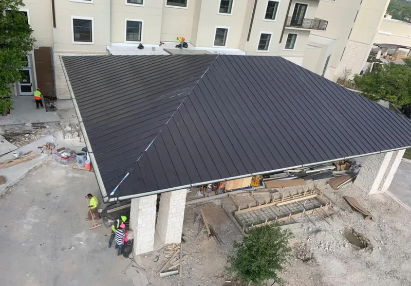 Metal roofing installation team working on a commercial building in Marlborough